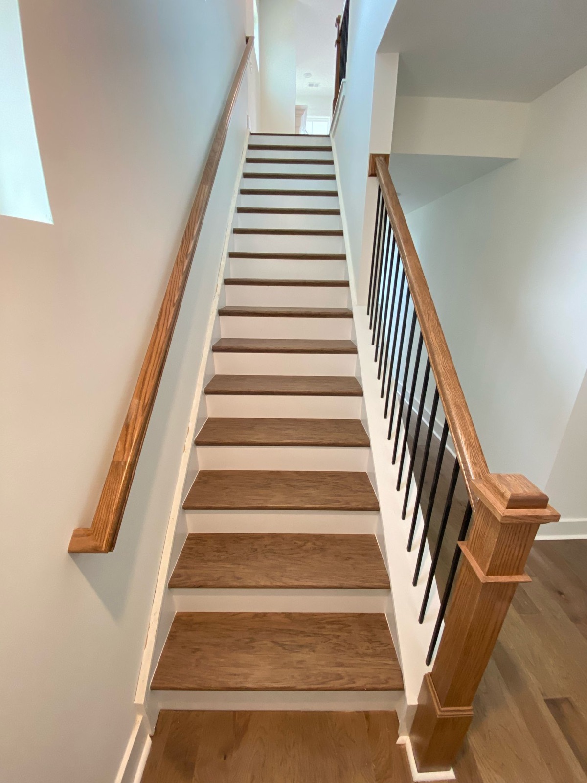 Oak staircase with iron balusters and wood handrail